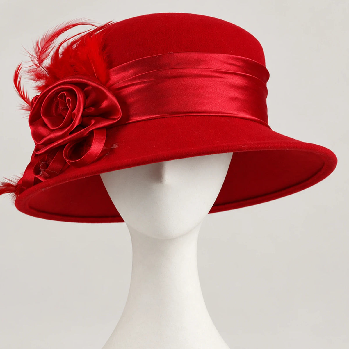 Red Z026H wool church hat with matching satin flowers and feather detail on a white mannequin