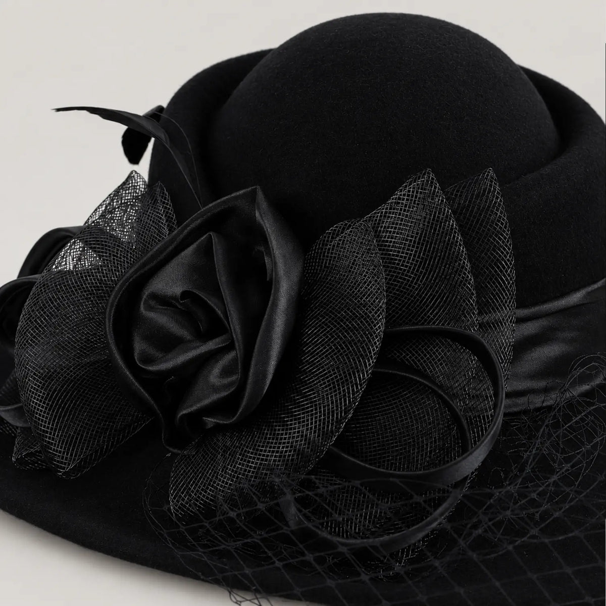 Close view of the black layered ribbon flower and mesh veil on the Z029B hat.