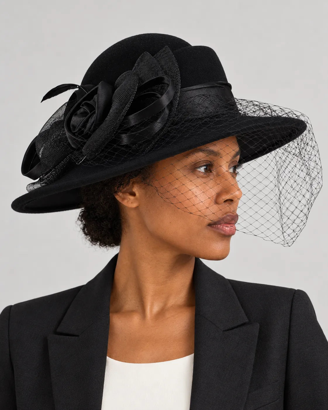 Side portrait of a woman wearing the black Z029B hat with the mesh veil across part of her face.
