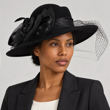Woman in a dark jacket wearing the black Z029B wide brim hat in a gray studio portrait.