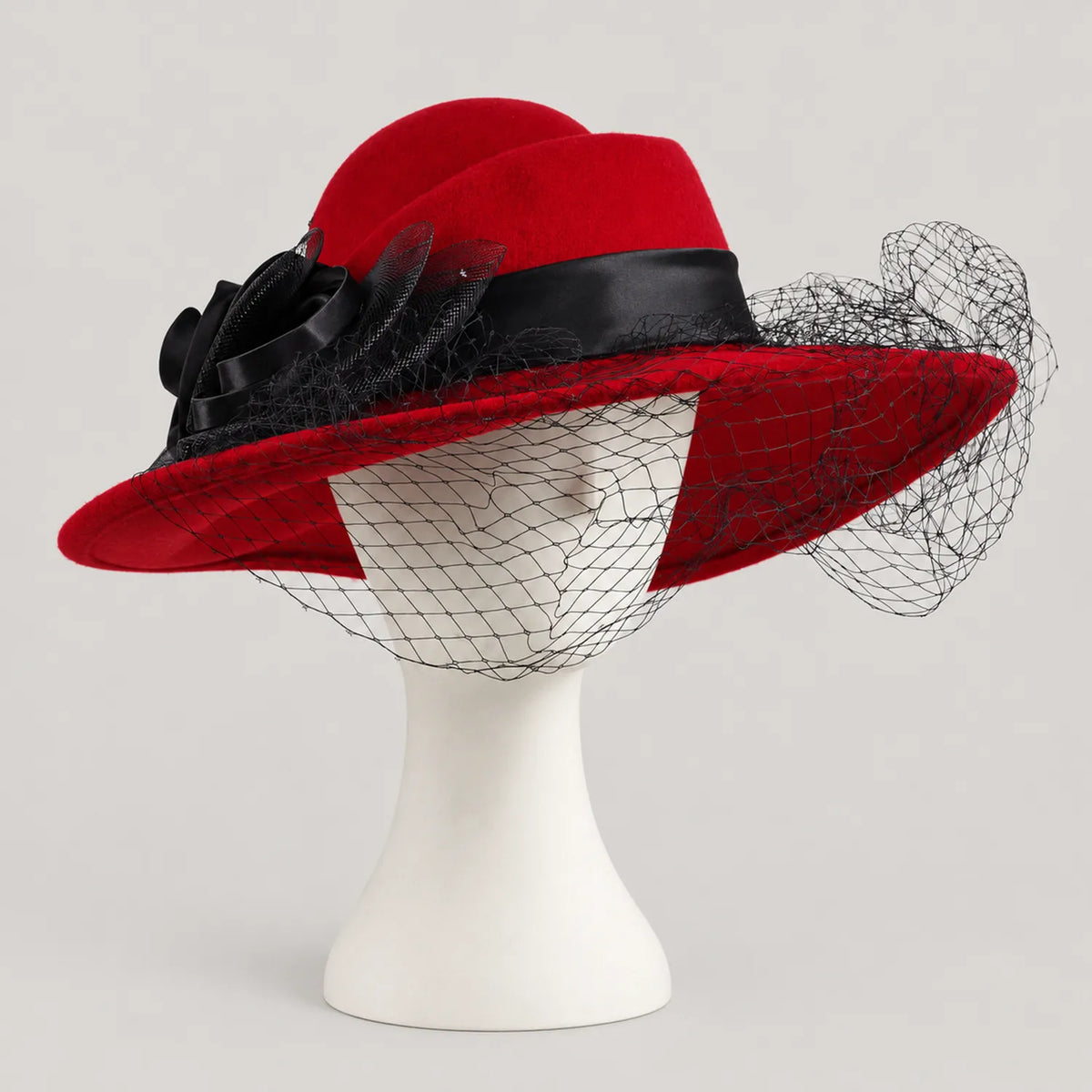 Red Z029B wide brim hat on a white mannequin with black flower trim and net veil across the front.
