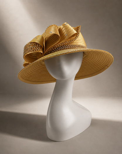 Gold wide brim church hat displayed on mannequin featuring elegant bow accents and rhinestone embellishments for church and special occasions.