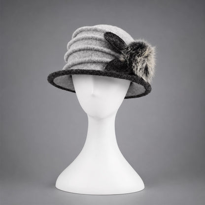 Front view of a gray boiled wool cloche hat with a short contrasting brim