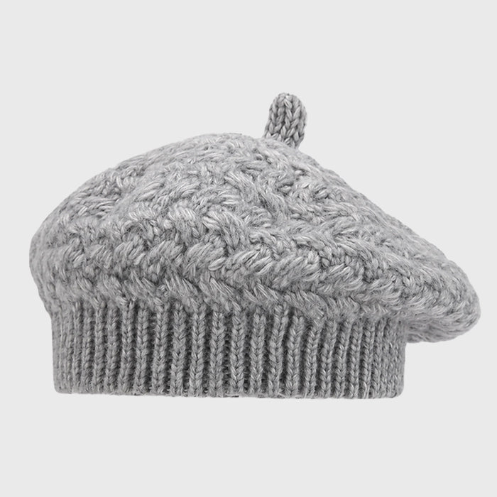 Stylish gray crochet cable knit beret for women. Adjustable size and cozy warmth, perfect for completing your winter look.
