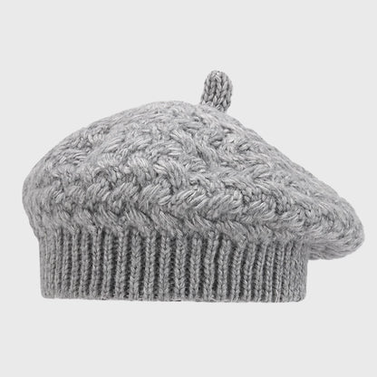 Stylish gray crochet cable knit beret for women. Adjustable size and cozy warmth, perfect for completing your winter look.