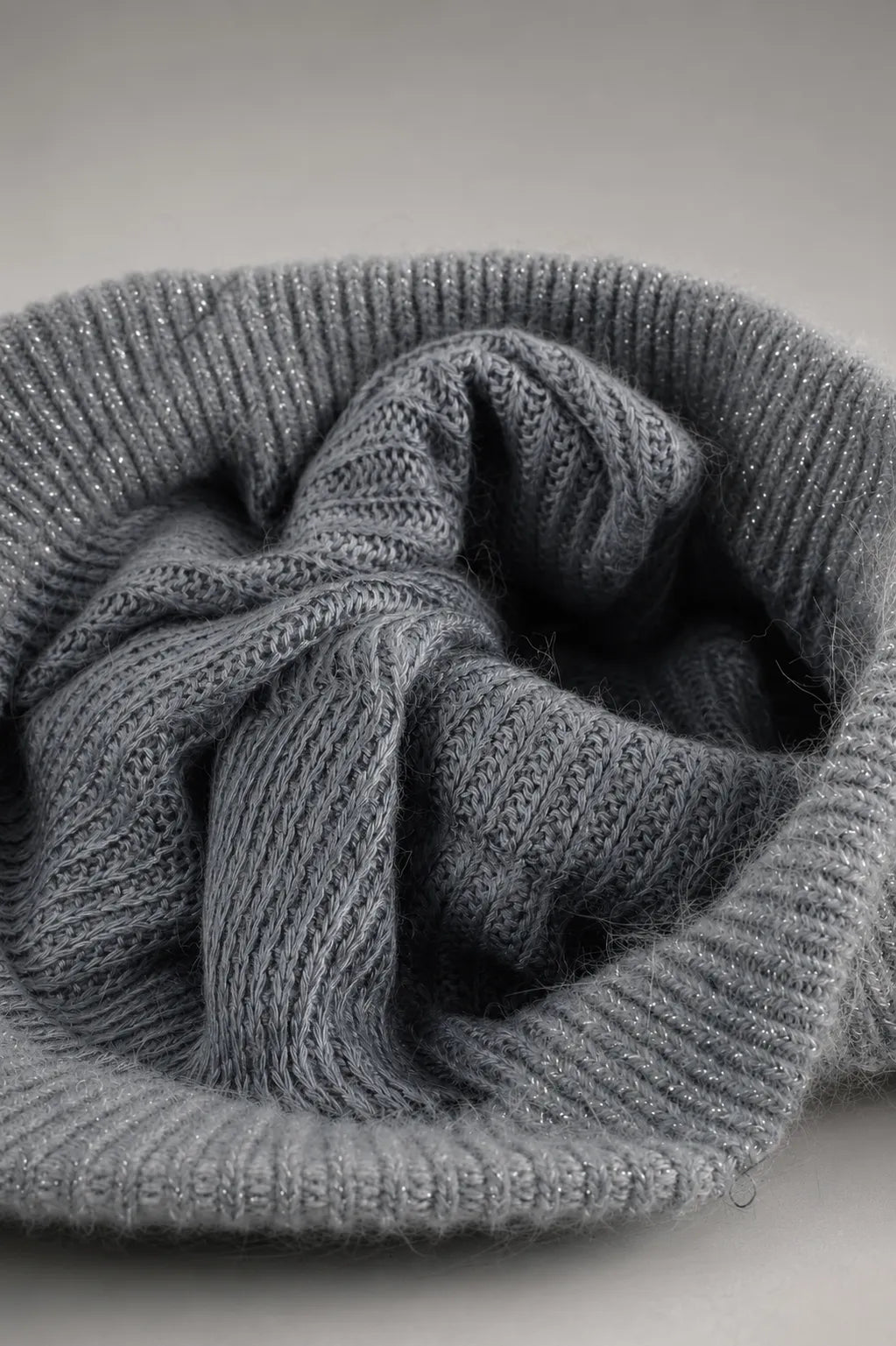 Interior fabric lining of a gray women’s knit visor beanie