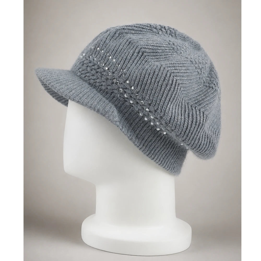 Side view of a gray women’s knit visor beanie showing the short brim and relaxed crown