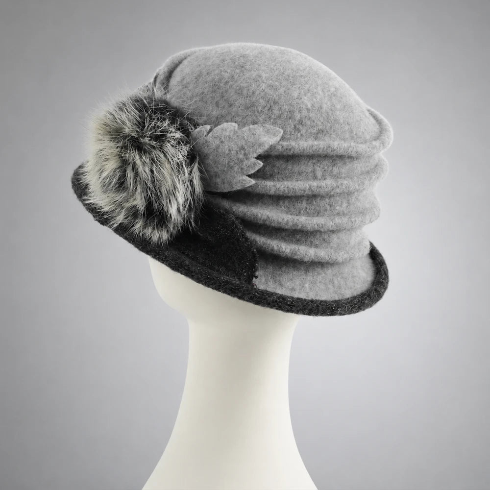 Rear side view of a gray wool cloche hat showing layered crown ruching