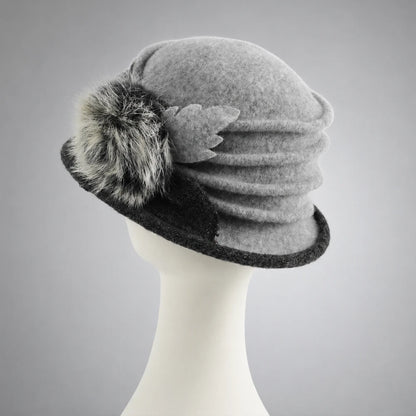 Rear side view of a gray wool cloche hat showing layered crown ruching