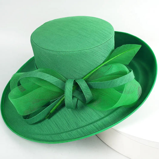  Top view of green church hat with feather and mesh bow detail – FORBUSITE