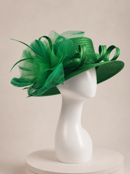 Side view of emerald green wide brim church hat on mannequin with decorative mesh flower and ribbon loops, elegant formal women’s hat
