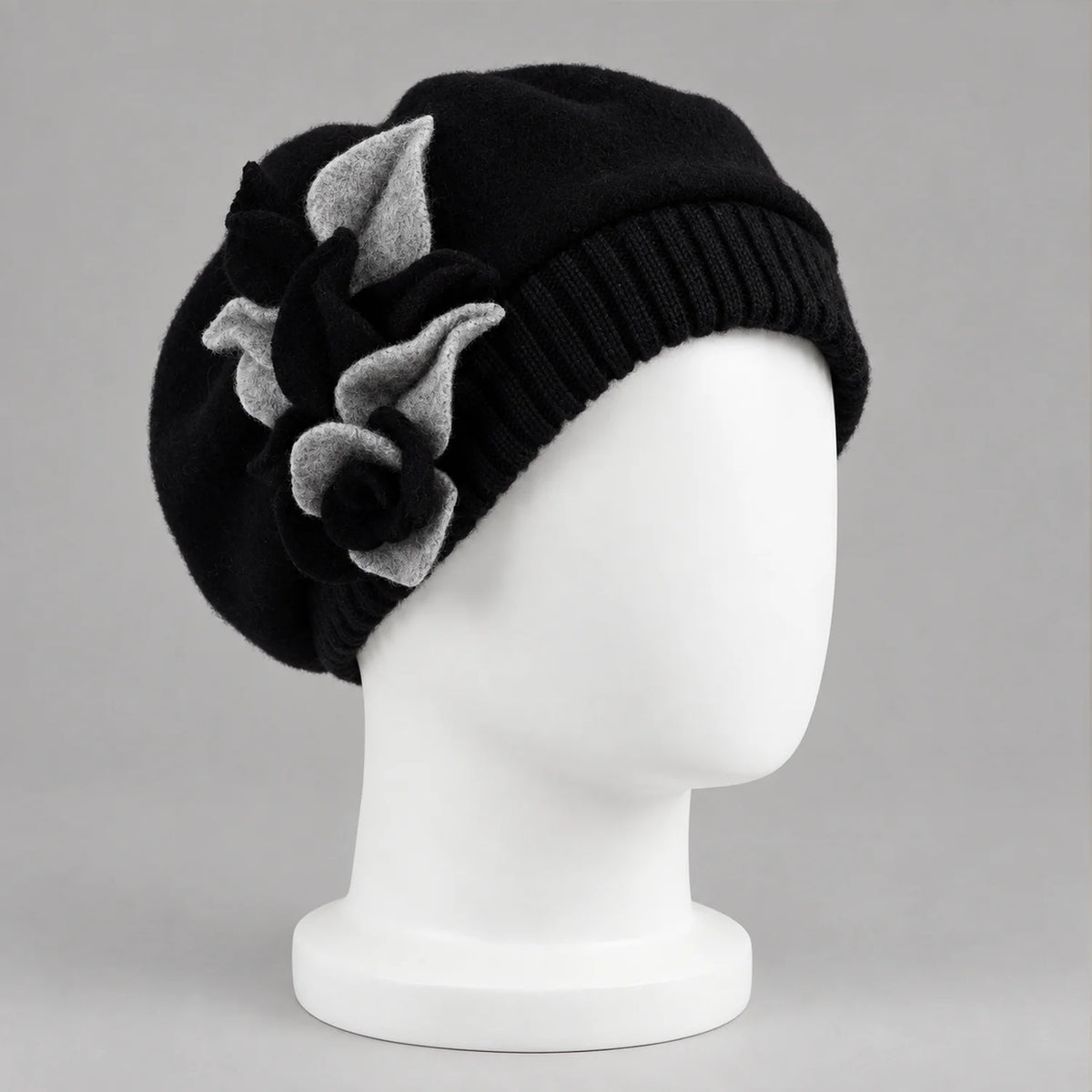 Black floral beret on a white mannequin, three-quarter view