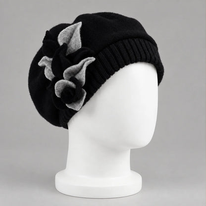 Black floral beret on a white mannequin, three-quarter view
