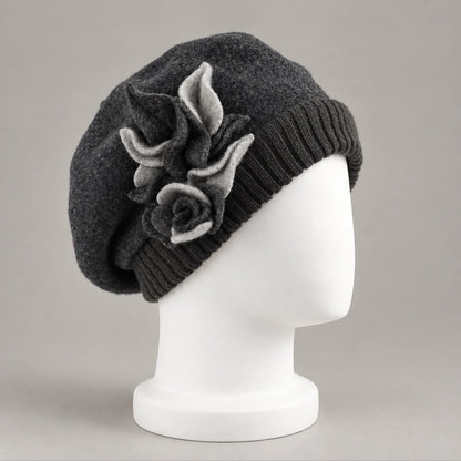 Charcoal gray floral beret on a white mannequin, three-quarter view