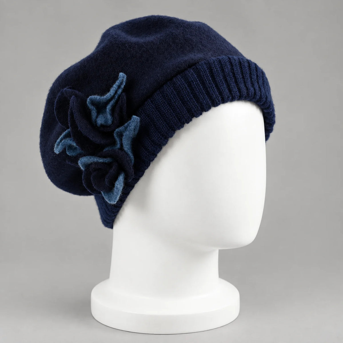 Navy floral beret on a white mannequin, three-quarter view