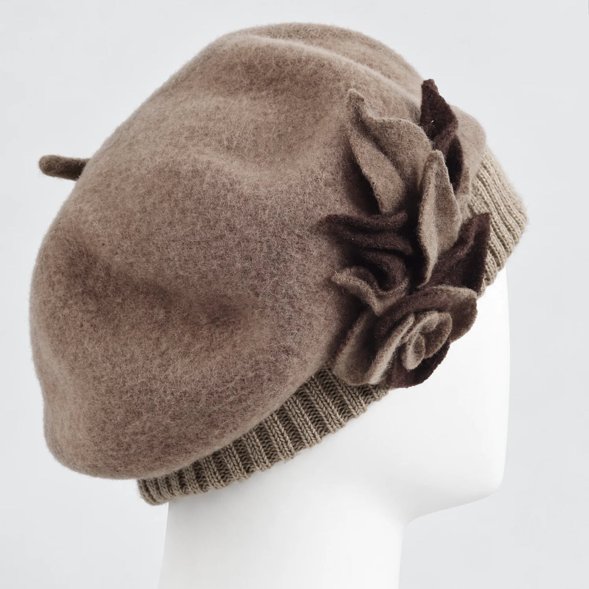 Side view of the taupe floral beret on a white mannequin