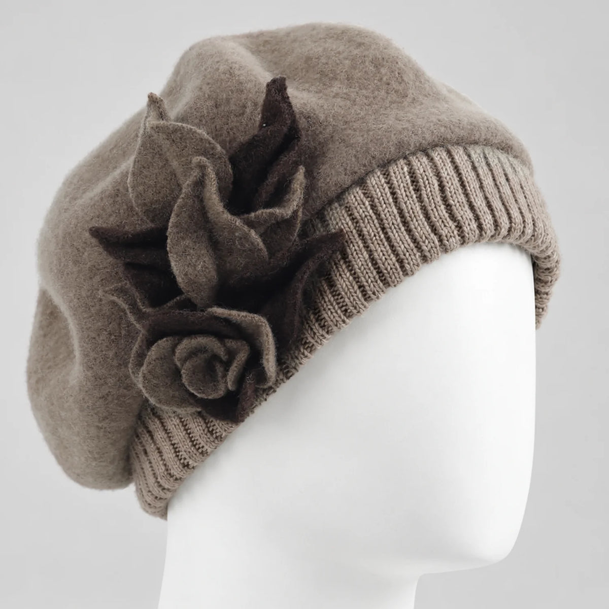 Taupe floral wool beret with a rounded crown and rib-knit band on a white mannequin