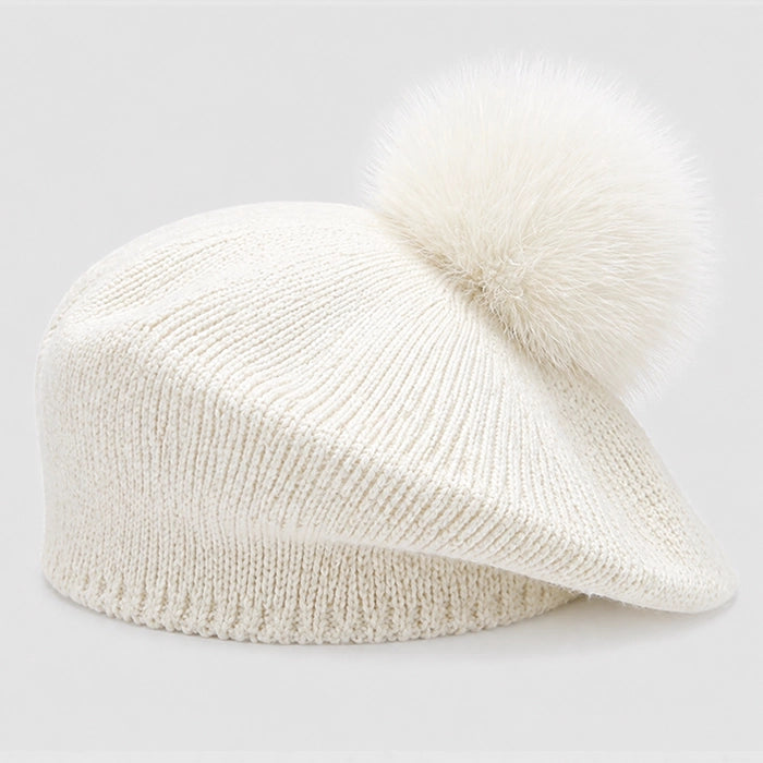 Elegant ivory beret with pom-pom for a sophisticated winter look. Soft knitted fabric for added warmth.