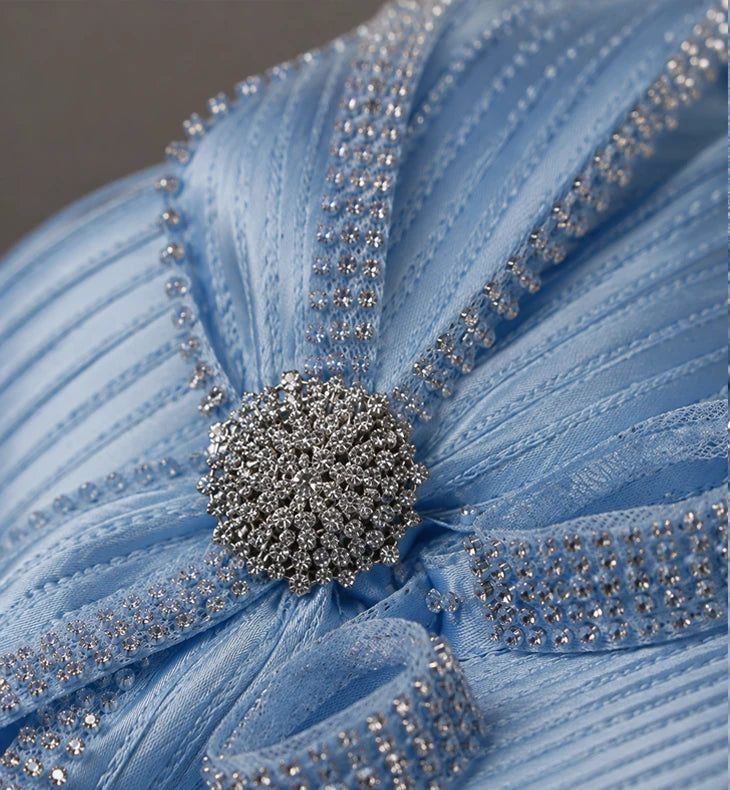 Close-up of light blue church hat with rhinestone decoration, elegant formal headwear for women.
