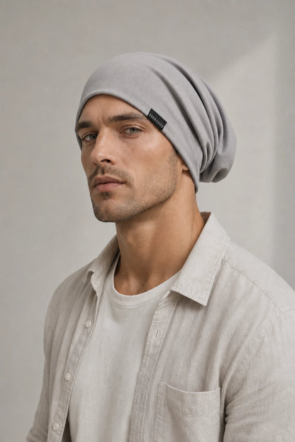 Man wearing a light gray lightweight slouchy beanie with soft folds behind the head
