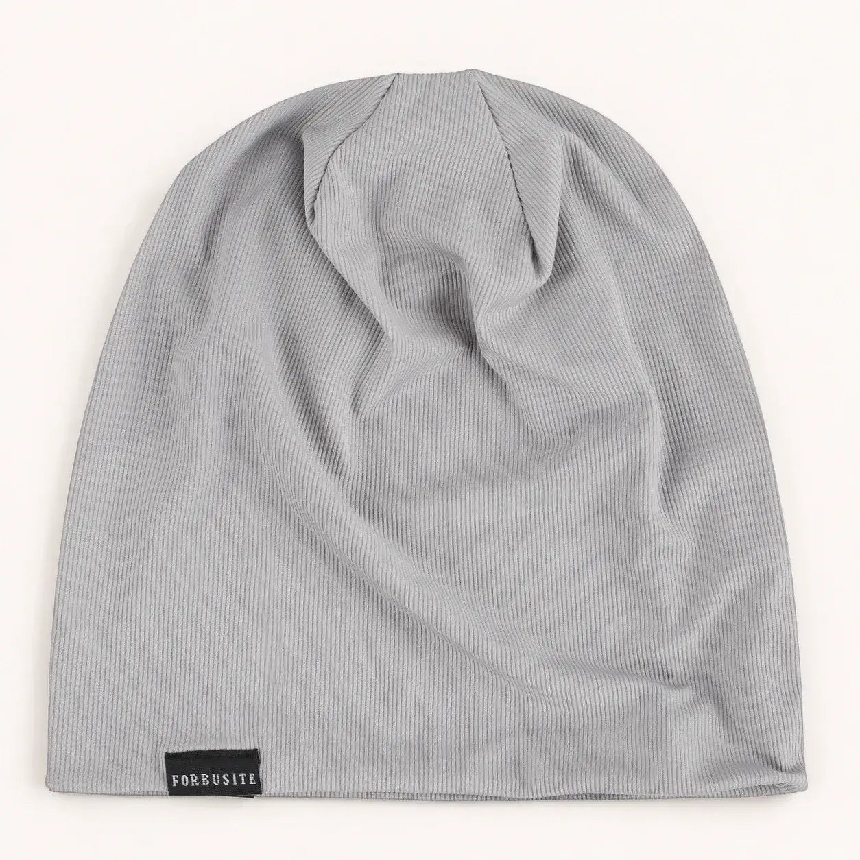 Light gray lightweight slouchy beanie hat with soft ribbed surface and FORBUSITE label