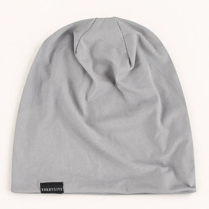 Light gray lightweight slouchy beanie hat with soft ribbed surface and FORBUSITE label