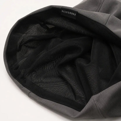 Inside view of a lightweight slouchy beanie showing the inner lining and finished edge