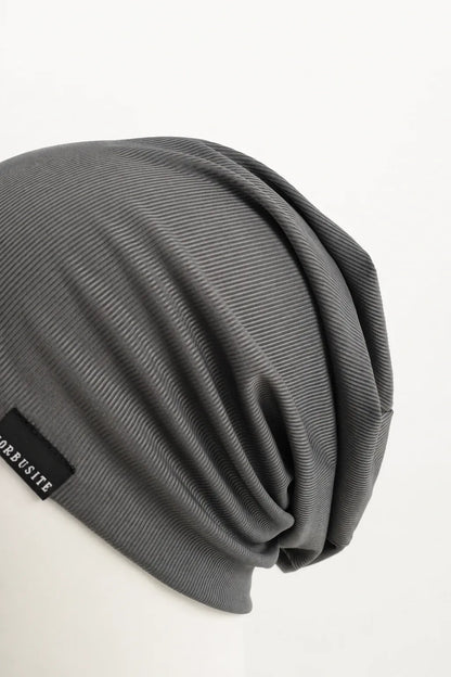 Close-up of the soft fine ribbed fabric and natural folds on a lightweight slouchy beanie