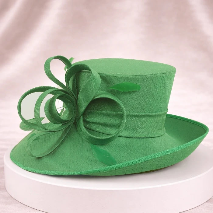 Luxurious green church hat with floral ribbon decoration for women, ideal for church services, weddings, and garden parties