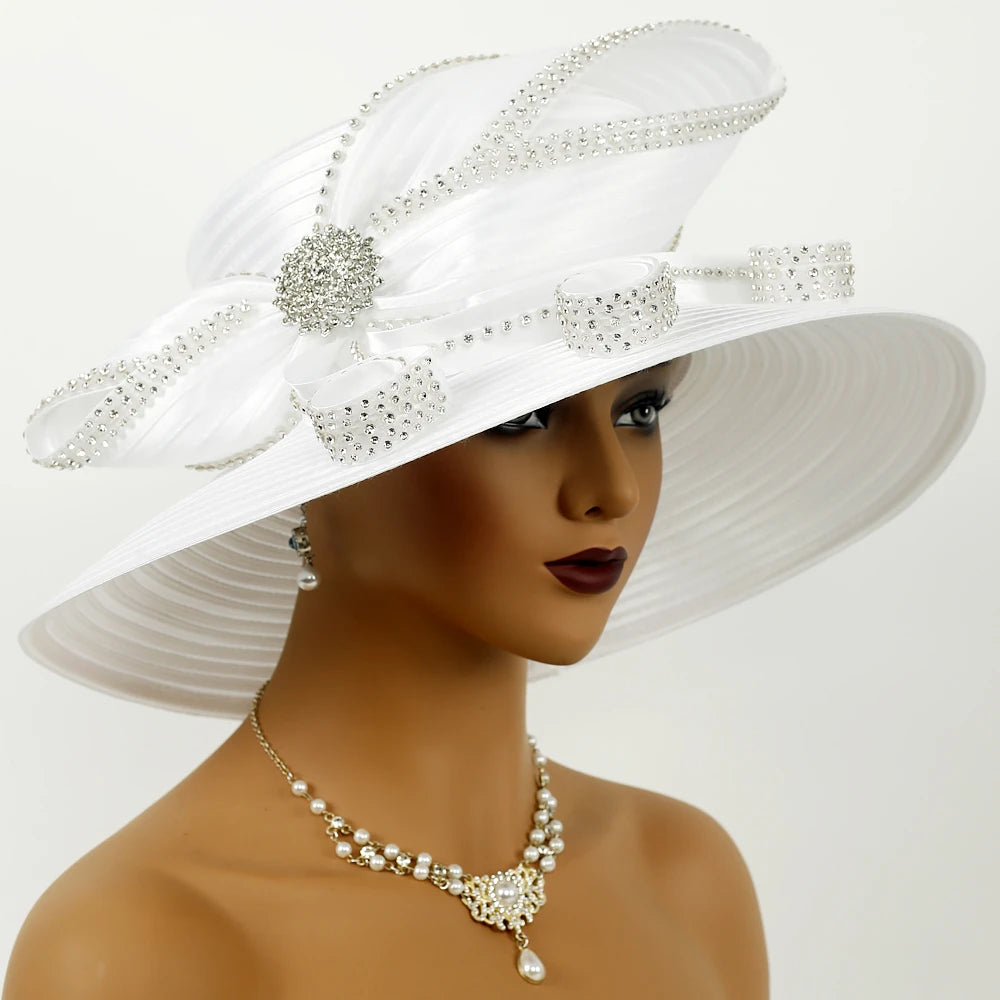 Side view of dramatic white church hat with crystal trim and satin loops