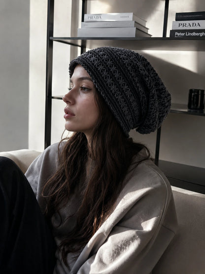 Woman wearing minimalist slouchy beanie in modern fashion editorial indoor setting