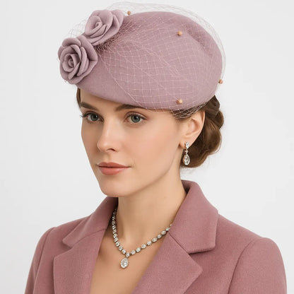 Lady in rose pink birdcage veil fascinator hat with floral detail