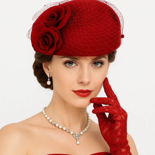 Woman wearing red pillbox fascinator hat with roses and birdcage veil