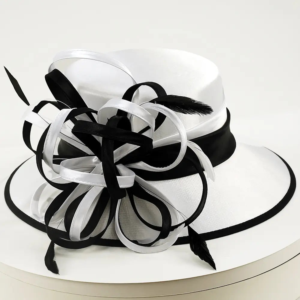 Elegant white and black wide brim church hat with feather loops by FORBUSITE