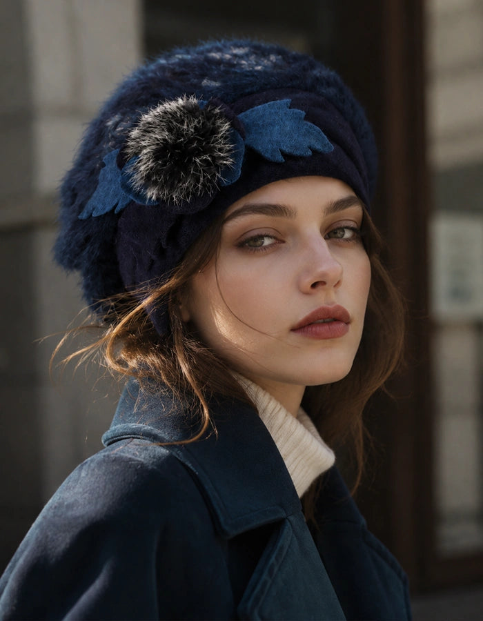 Navy blue angora wool beret with flower detail styled with winter coat