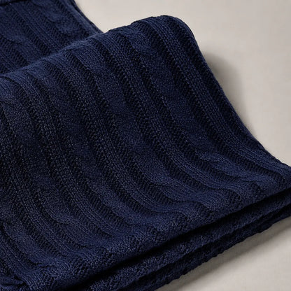Close-up texture of navy blue knit scarf, soft warm winter loop scarf fabric detail, premium unisex knitted scarf for cold weather fashion