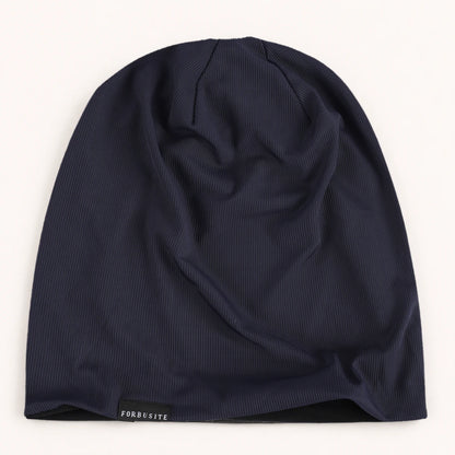 Navy blue lightweight slouchy beanie with smooth ribbed fabric and relaxed uncuffed shape