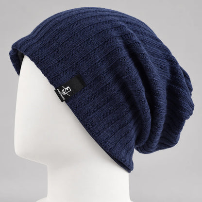 Navy slouchy knit beanie with a long relaxed crown and soft drape