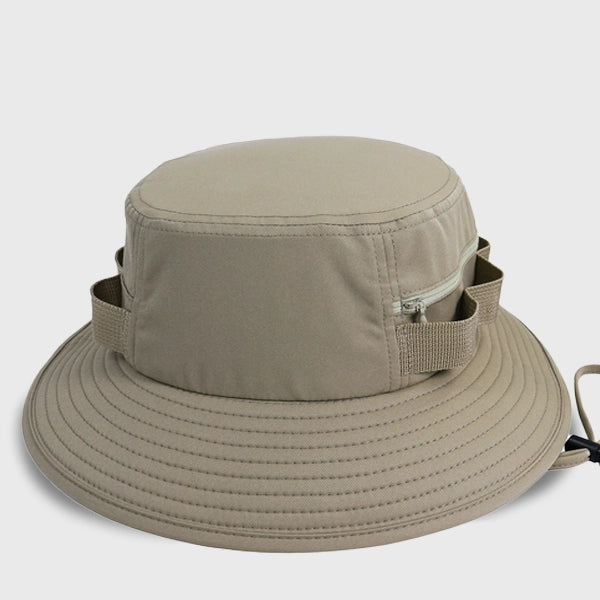 Beige outdoor adventure sun hat with UPF50, perfect for hiking and outdoor trips, featuring a bucket hat design with a drawstring for secure fit and side zipper pockets.