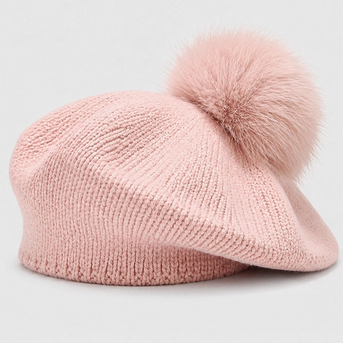 Soft pink beret with pom-pom, ideal for adding a pop of color to your winter wardrobe.