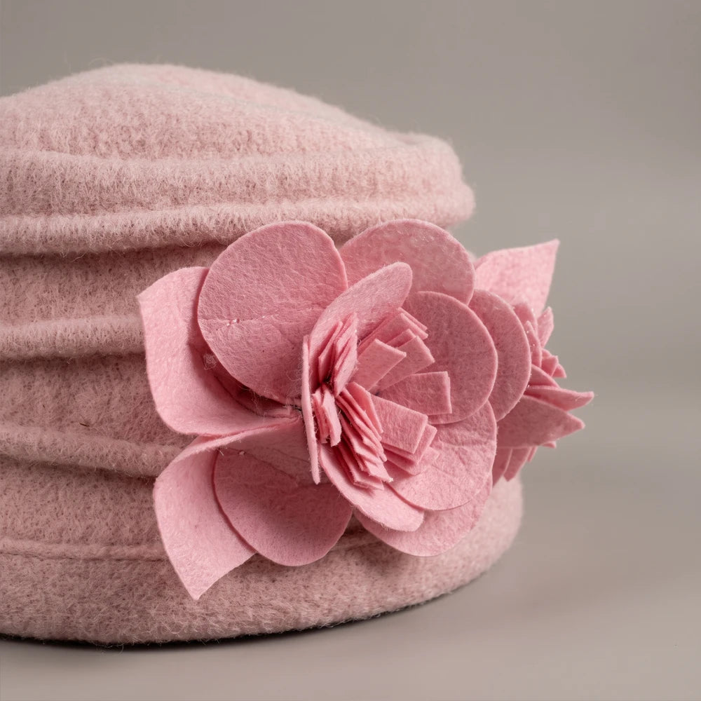 Close-up of the fixed non-woven flower and ruched crown on a pink boiled wool hat