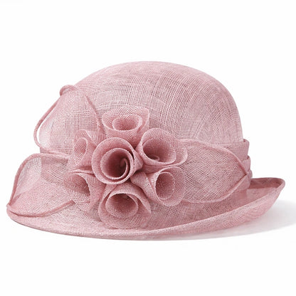Chic pink cloche sinamay hat adorned with flower accents, ideal for weddings, formal ceremonies, and garden parties.