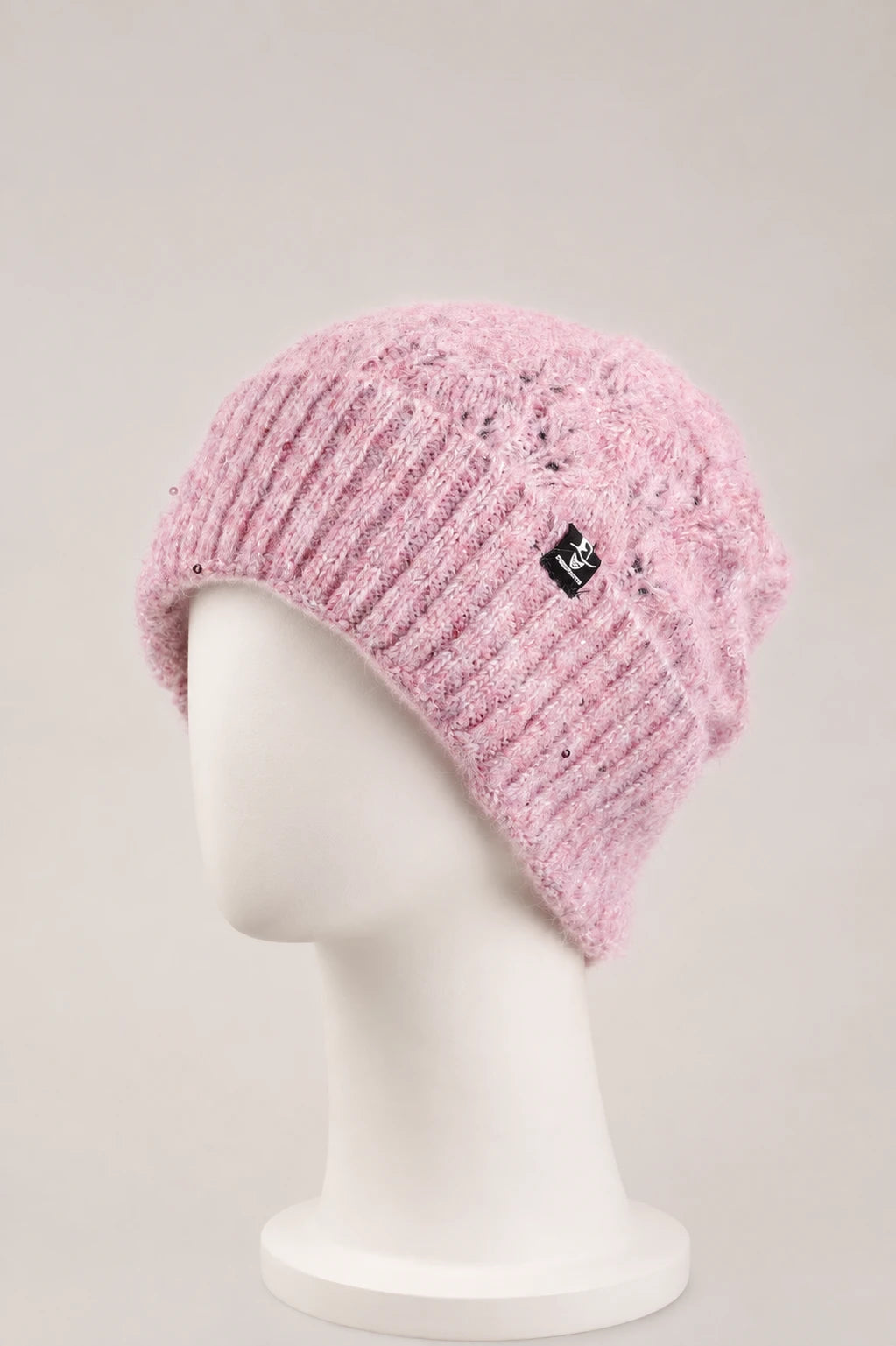 Pink fuzzy sequin cuffed beanie displayed on a matte white mannequin.
