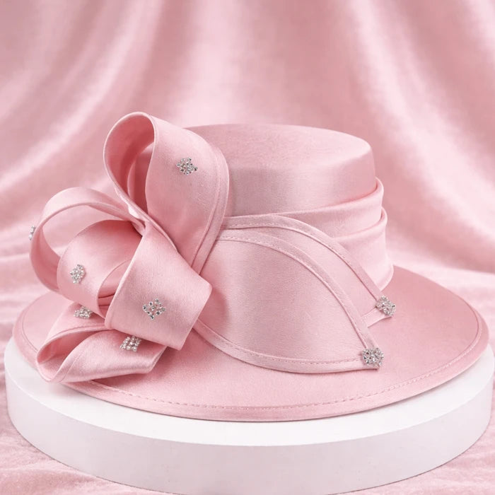 Charming pink satin church hat with crystal accents, ideal for weddings and Easter services.