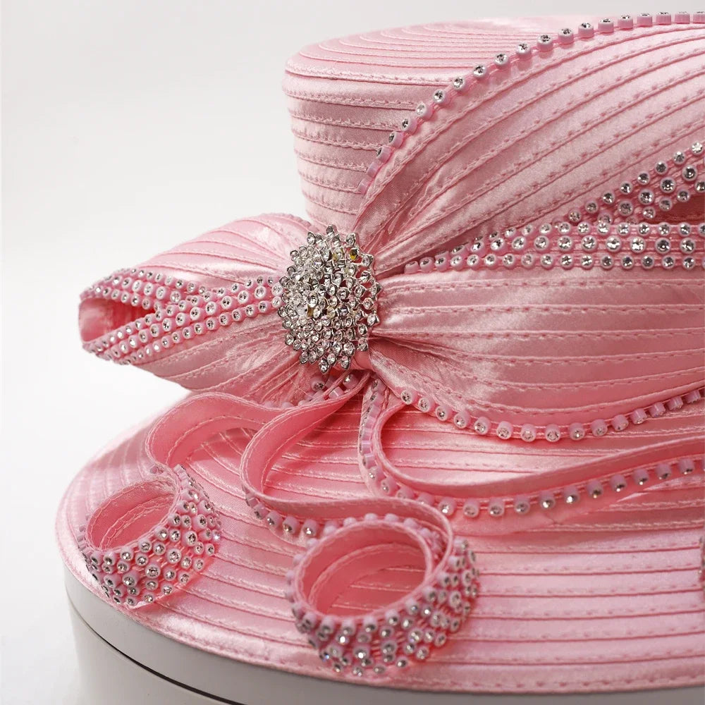 Close-up of rhinestone bow and swirl design on pink satin church hat