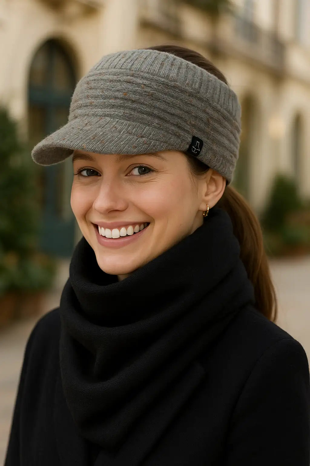 Smiling woman in grey fleece visor beanie hat with ponytail