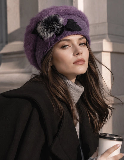 Purple angora wool beret with flower accent styled with black coat for winter