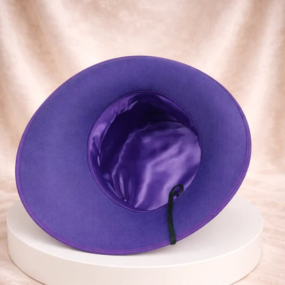 Purple formal hat with feather details, ideal for wedding guests and church celebrations.