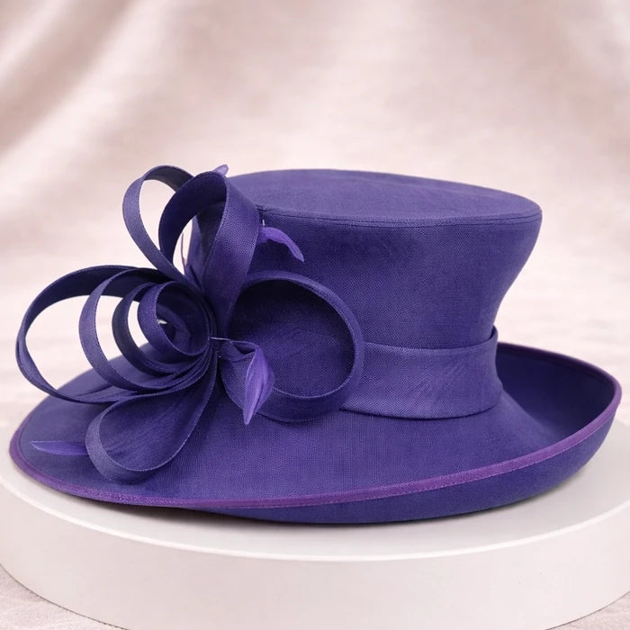 Purple formal church hat with elegant ribbon detailing, perfect for weddings and church services.