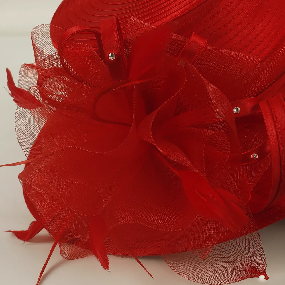Close-up of red church hat fabric texture and decorative netting with rhinestone details, highlighting high-quality craftsmanship for formal women’s hat